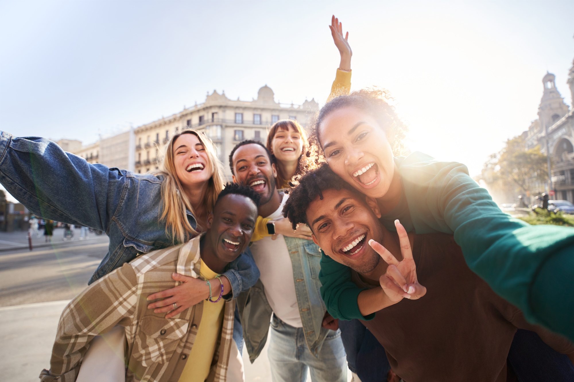 A group of cheerful students college friends taking a selfie as they travel through European cities.